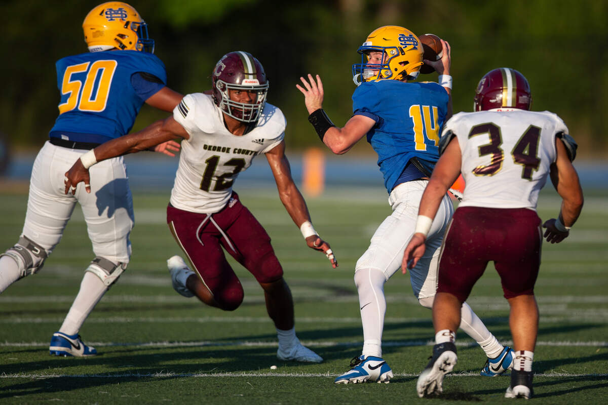George County linebacker TJ Love (#12) looks to tackle St. Martin quarterback Cameron Romero during a Jamboree game against St. Martin at St. Martin High School in Ocean Springs on Friday, Aug. 23, 2024.