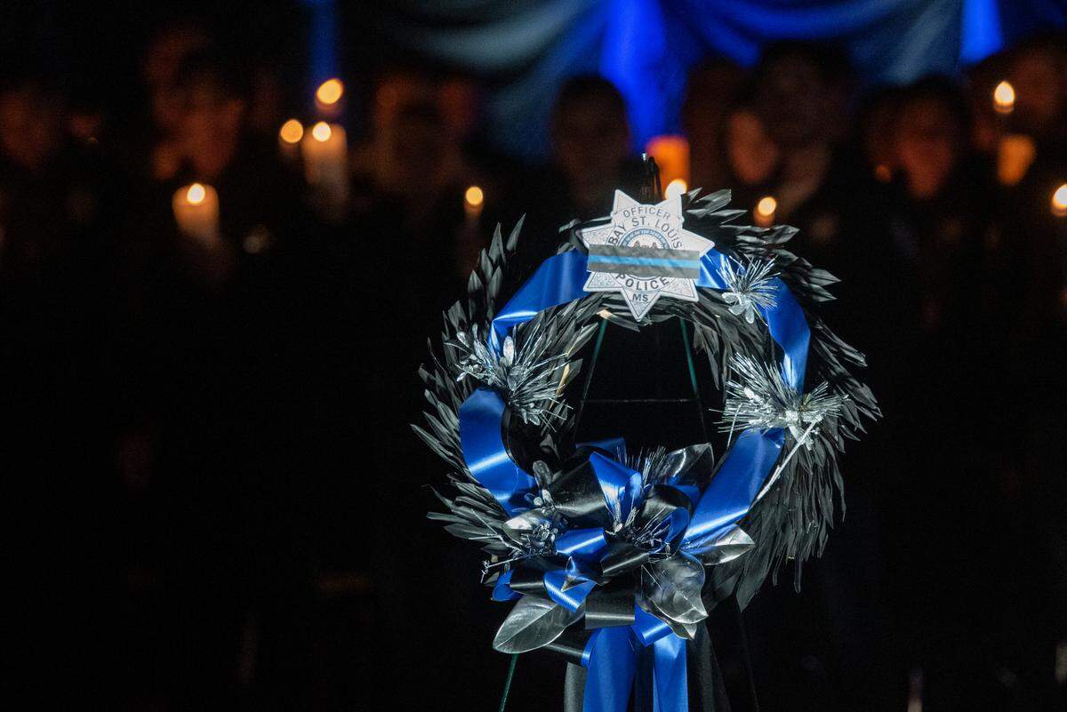 A wreath for Bay St. Louis Sgt. Steven Robin and officer Branden Estorffe during a candlelit vigil in honor of the officers at Tiger Stadium in Bay St. Louis on Thursday, Dec. 15, 2022. Robin and Estorffe were killed on Wednesday when a woman shot both of them.