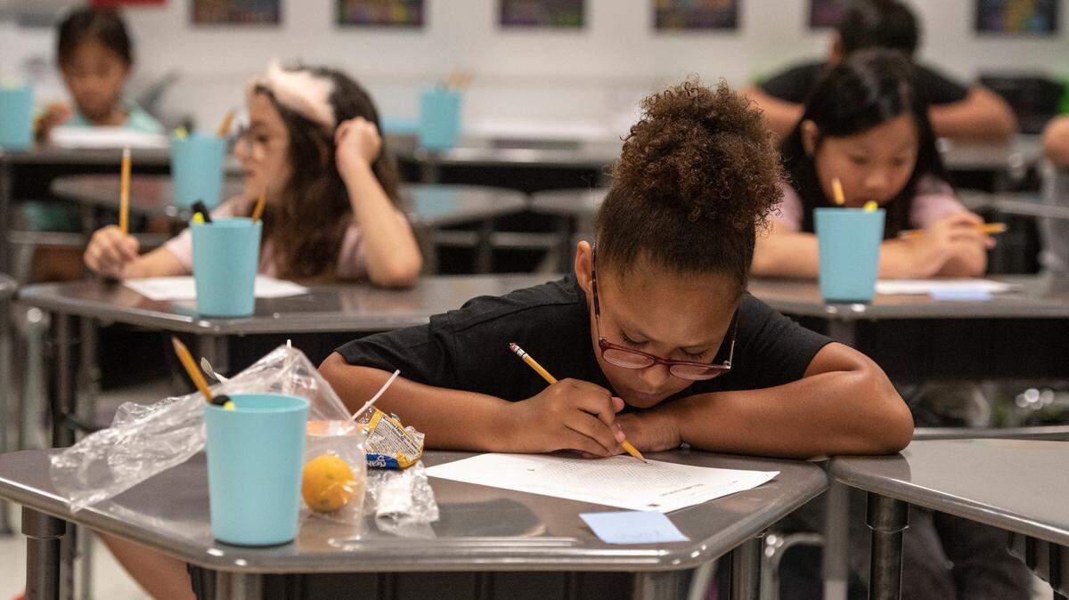 Students work on worksheets on the first day of school at North Bay Elementary School in Biloxi in July.