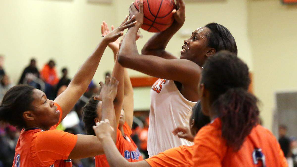AMANDA McCOY/SUN HERALD 
 West Harrison's Ameshya Williams attempts a shot while surrounded by the Gulfport defense on Tuesday, December 15, 2015, at West Harrison High.