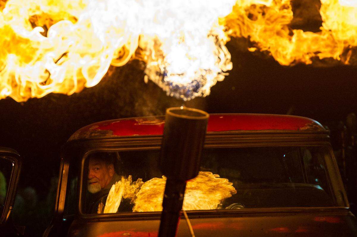 Ricky Bobby watches flames shoot out of his 1958 Chevy Apache during a flame throwing competition, where drivers compete to see which car can produce the biggest flames, at Island View Casino in Gulfport during Cruisin’ The Coast on Tuesday, Oct. 5, 2021.