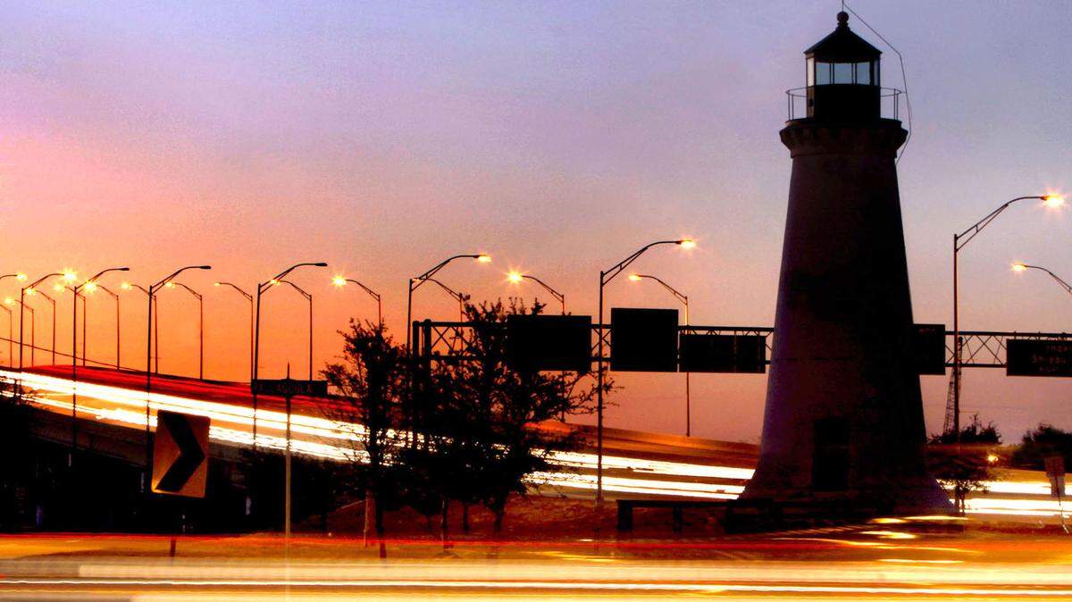 TIM ISBELL/SUN HERALDTraffic lights are blurred as vehicles pass the Round Island Lighthouse in Pascagoula. The city is currently advertising a lighthouse keeper position. The job would include promoting the newly restored Round Island Lighthouse.