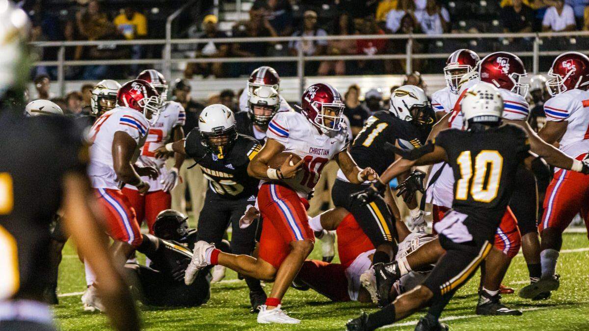 Greenville Christian’s D.J. Smith (10, with the ball) rambles for yardage against Oak Grove. Smith accounted for six touchdowns in the Saints’ 48-41 victory Friday night.