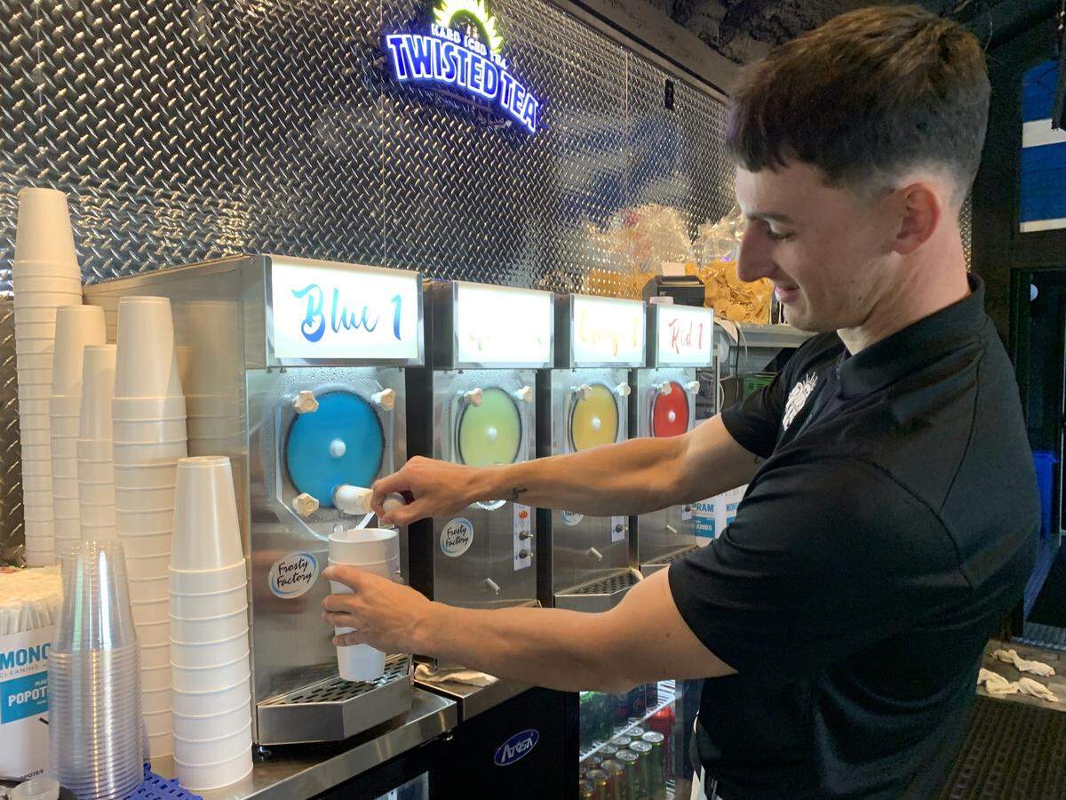 Tucker Thomas pours a wine daiquiri at the new Pier 15 on the Biloxi River. The river bar that’s also an entertainment and food venue, opens April 6 in Woolmarket.