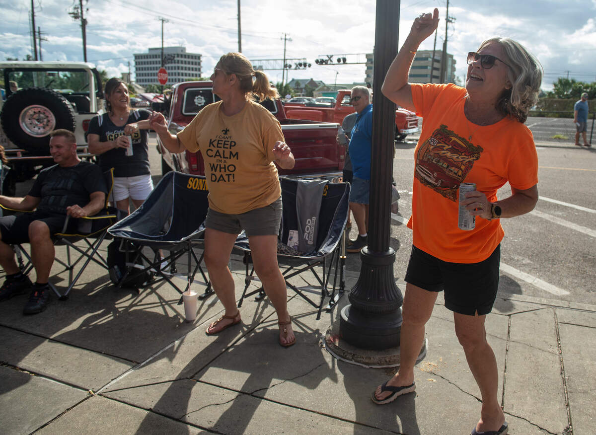 Roxie, center, and Pat, right, who only wanted to be identified by their first names, dance during View the Cruise, one of the first events of Cruisin’ the Coast on Sunday, Oct. 3, 2021.