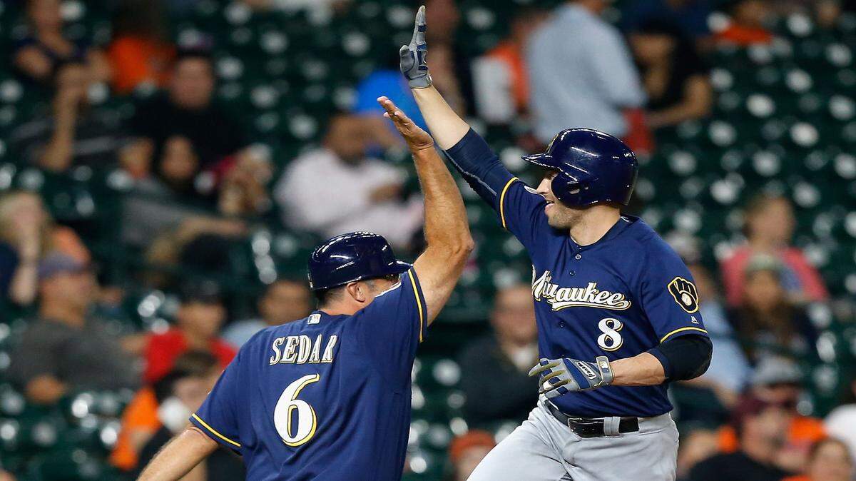 BOB LEVEY/ASSOCIATED PRESS 
 Milwaukee Brewers' Ryan Braun (8) receives a high five from third base coach Ed Sedar (6) after hitting a home run in the second inning against the Houston Astros Thursday in Houston.