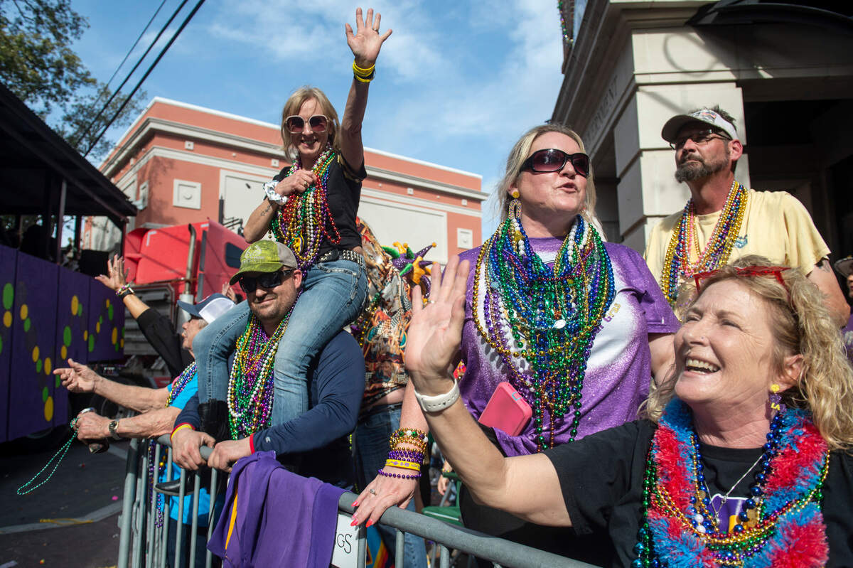 Parade watchers cheer for throws during the Ocean Springs Elks Club Mardi Gras Parade in Ocean Springs on Saturday, Feb. 15, 2025.