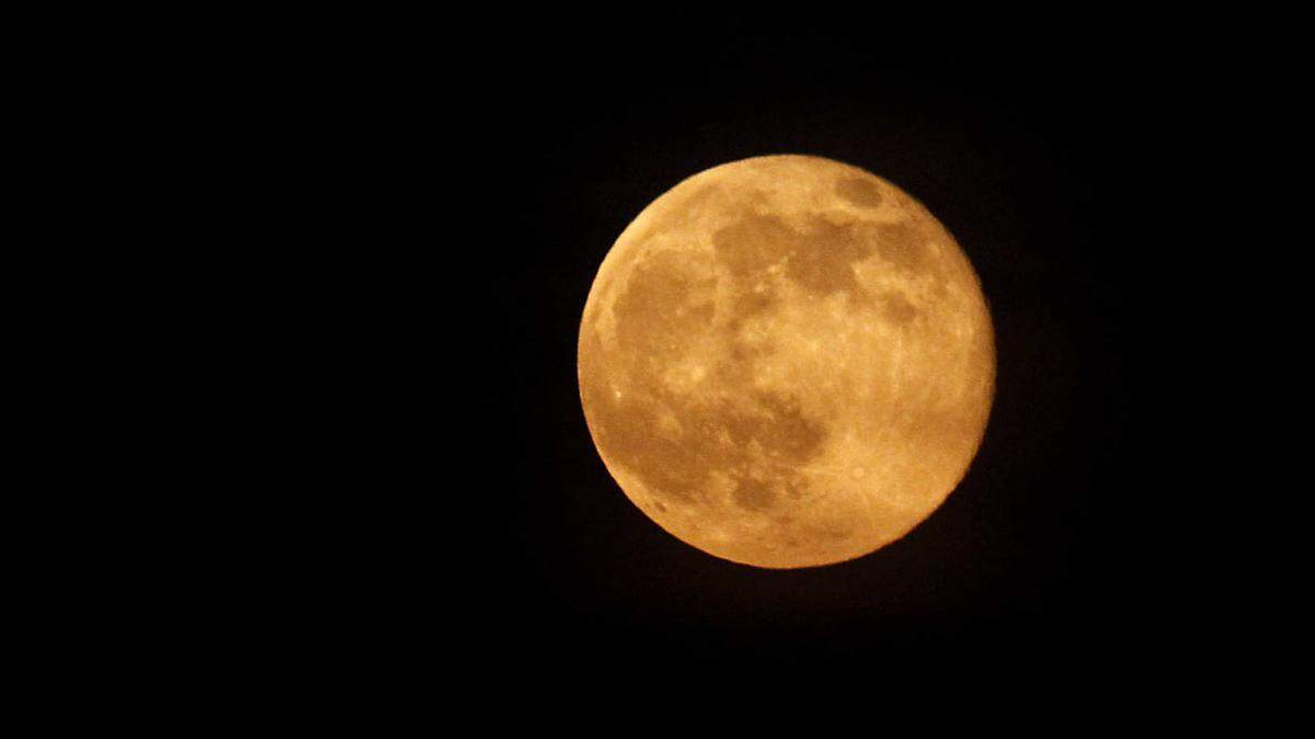TIM ISBELL/SUN HERALD 
 A supermoon makes its appearance over Gulfport in July 2014. The supermoon coincides with a full or new moon with the closest approach the moon makes on its elliptical orbit. Sunday will bring an eclipse of the supermoon, which won't happen again until 2033, but clouds could obscure the sight in South Mississippi.