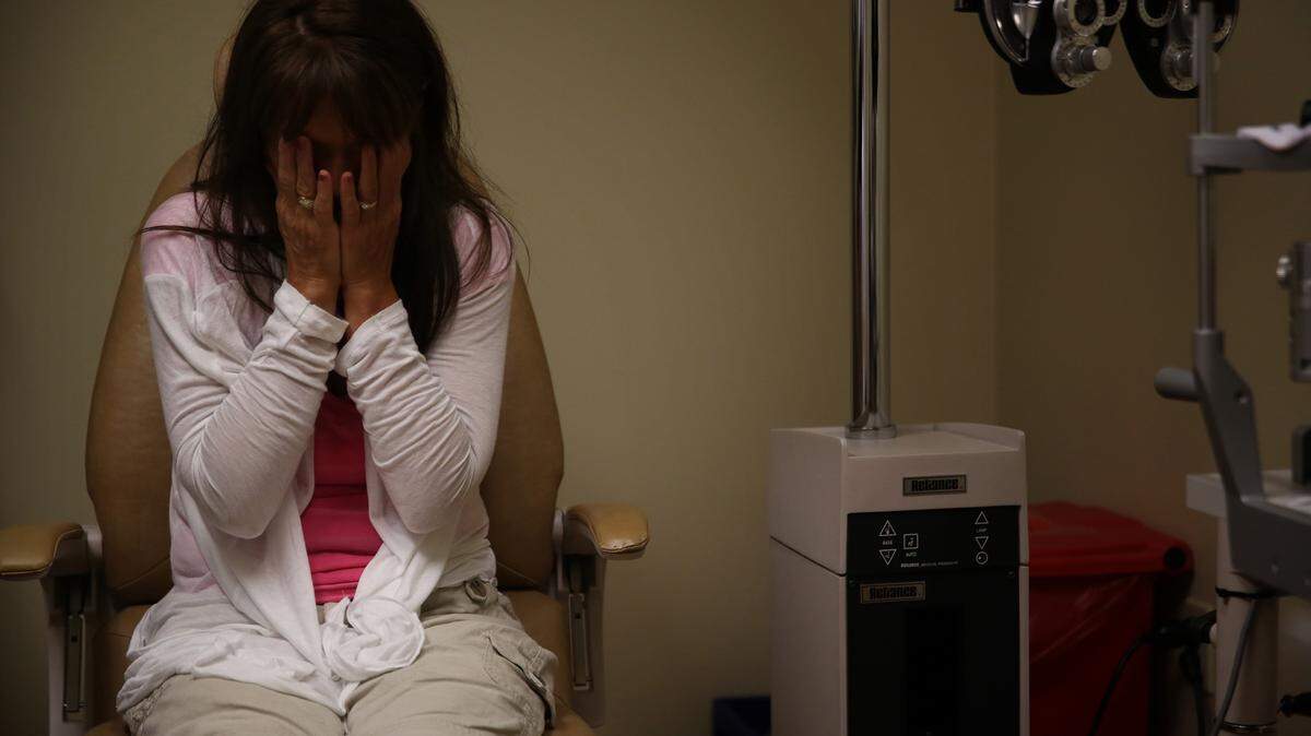 Becki Conway, a survivor of a deadly skin rash called Stevens-Johnson syndrome caused by a drug-drug interaction, has a consultation with a specialist at the Bascom Palmer Eye Institute in Naples, Fla., on September 22, 2014. The syndrome has left Conway blind in one eye and legally blind in the other. (E. Jason Wambsgans/Chicago Tribune/TNS)