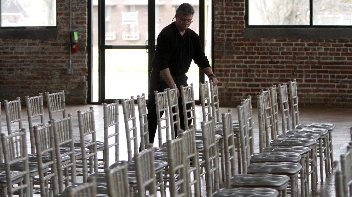 TIM ISBELL/SUN HERALD 
 Mike Reffalt begins the task of arranging chairs in preparation for Republican Presidential candidate John Kasich's visit to Gulfport. Kasich will speak at Cafe Climb.