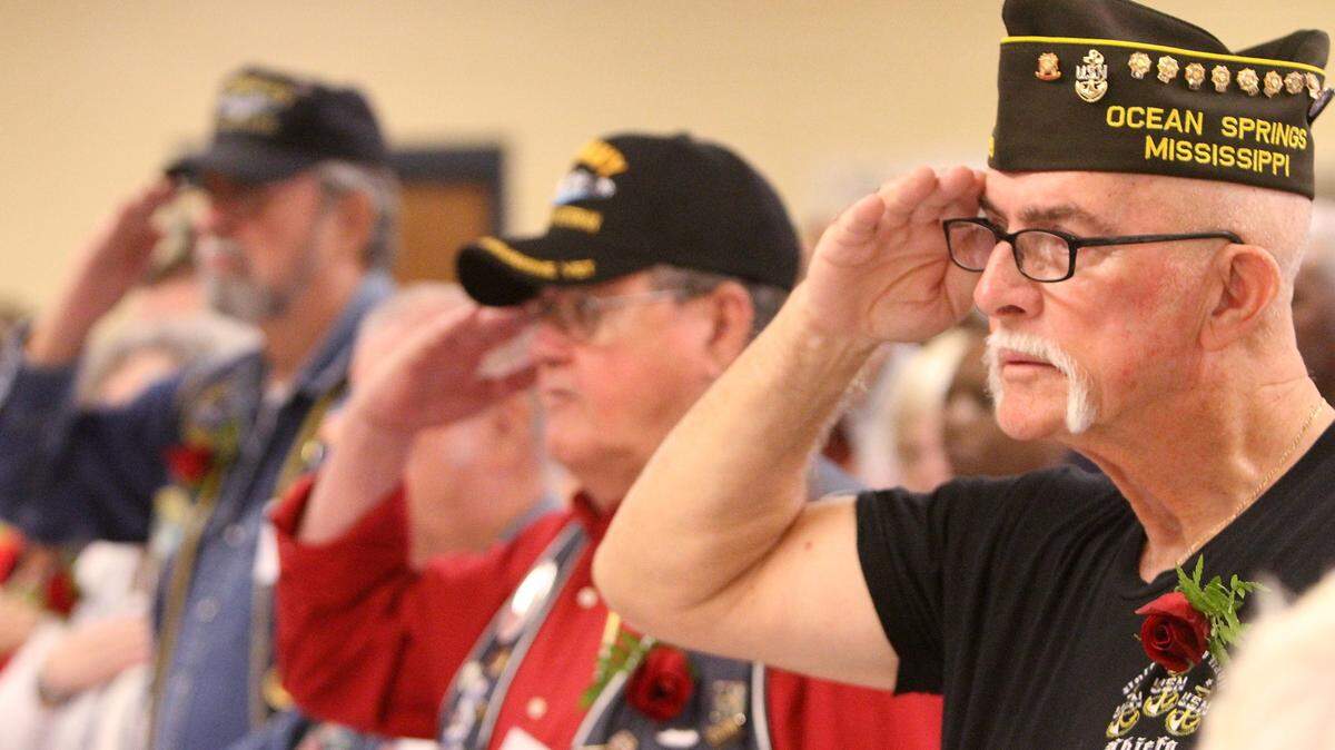 JOHN FITZHUGH/SUN HERALD 
 Navy veterans Joseph Pierce of Ocean Springs, from right, Herb Edmonds of Gautier and C.L. Harvey of Grand Bay, Ala., salute during the Gautier High School Veterans' Breakfast on Monday Nov. 9, 2015.