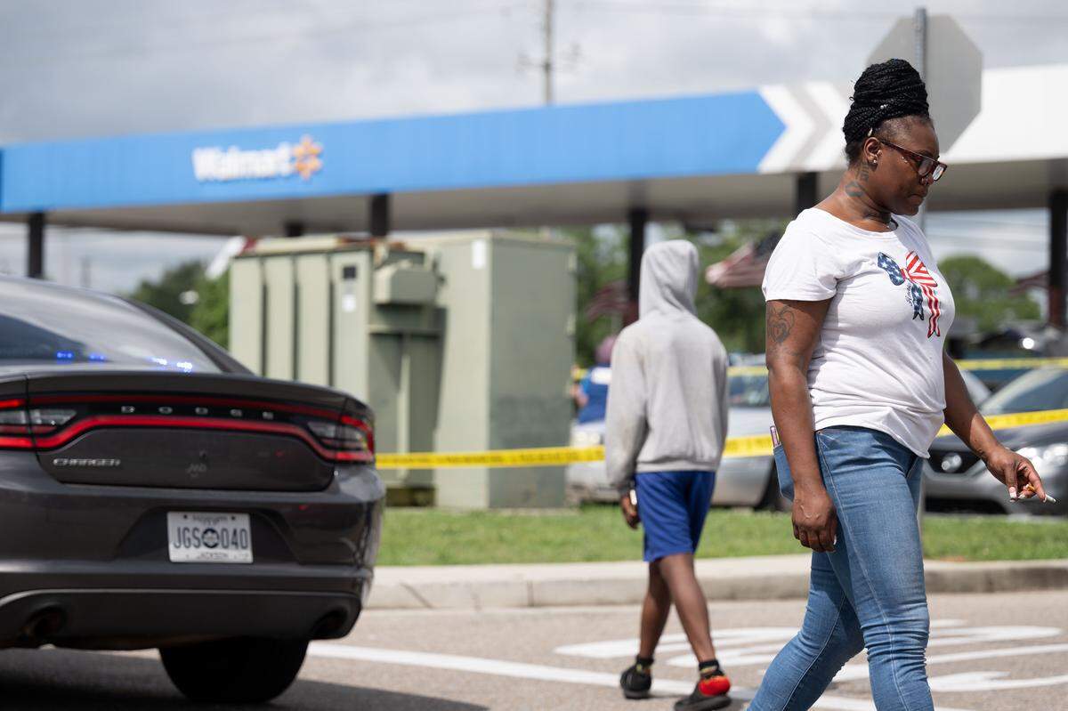 A woman walks past the scene of the shooting Tuesday in Gulfport.