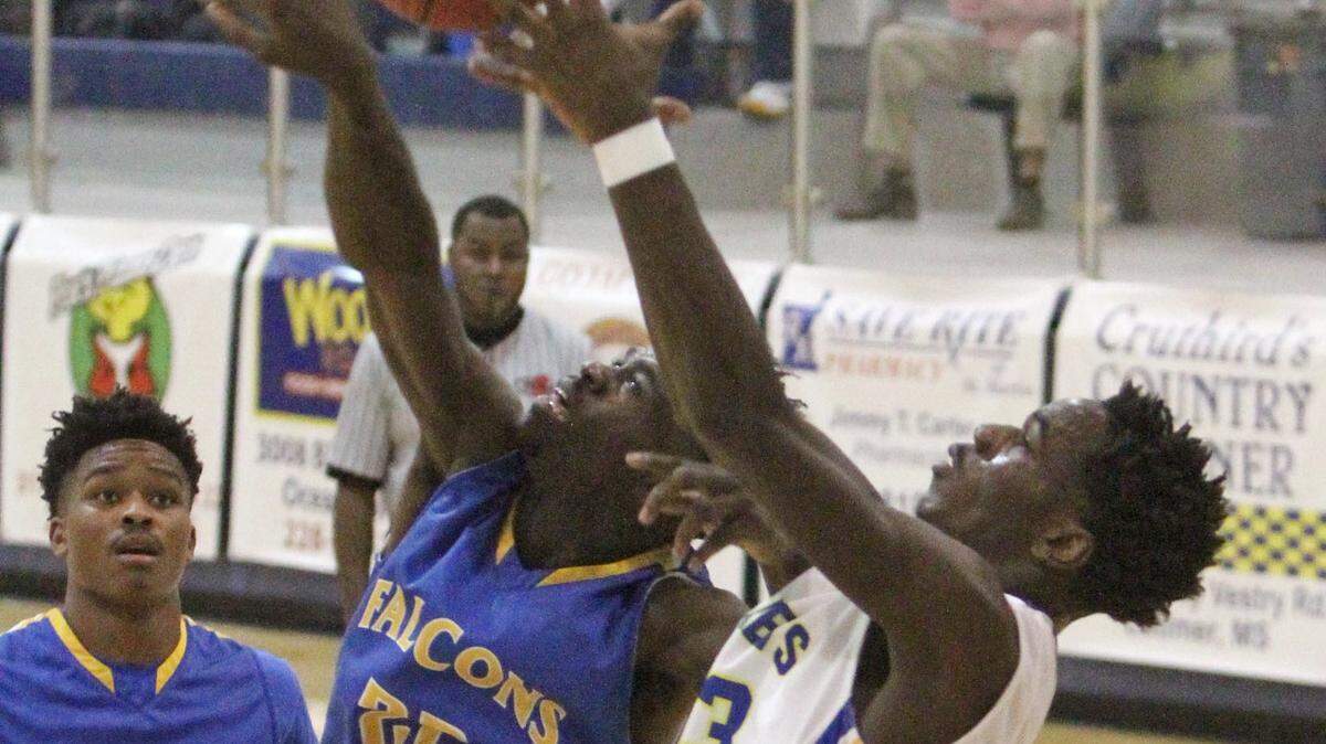 JOHN FITZHUGH/SUN HERALD 
 St. Martin's Johnnelius Anderson and Velma Jackson's Nicholas Rivers reach for a pass during the first quarter of their game in the Joe Barlow Tournament at St. Martin on Wednesday Nov. 25, 2015.