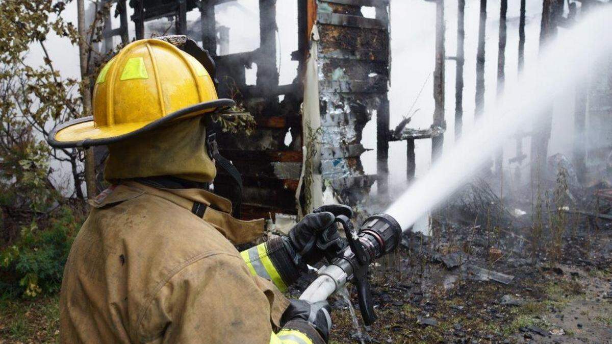PAT SULLIVAN/HARRISON COUNTY FIRE SERVICES 
 A firefighter helps put out a blaze that destroyed a Saucier home early Wednesday morning.