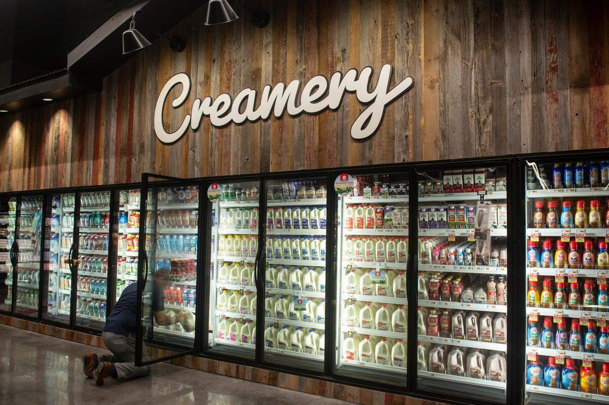 A worker stocks the dairy section at the new Rouses Market location on Pass Road in Biloxi on Tuesday, Oct. 15, 2024.