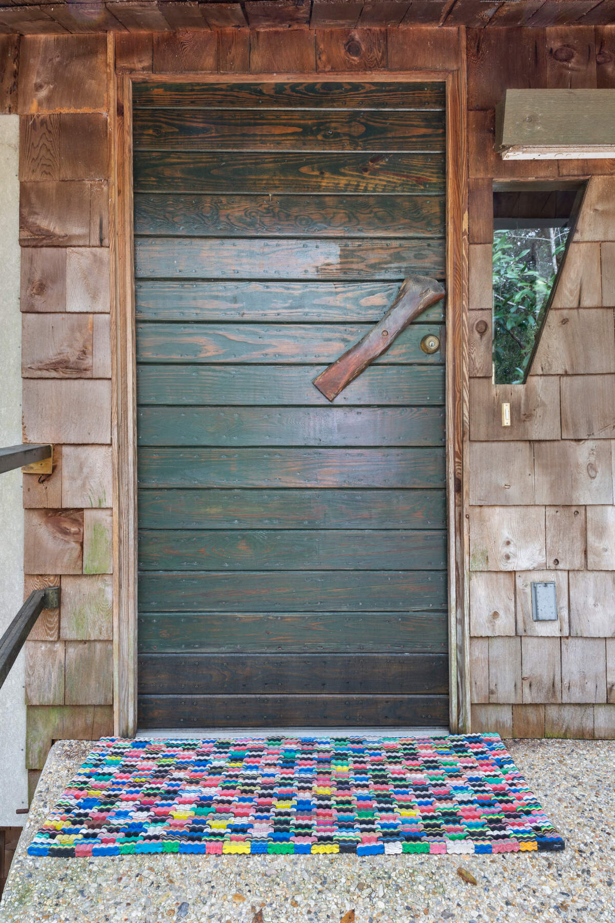 The entry door to this Ishee house on Brumbaugh Road in Ocean Springs features the builder/designer’s signature wood handle, as opposed to a door knob.