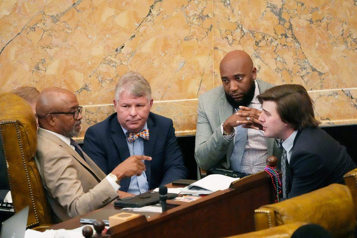Mississippi state Rep. Robert Johnson, D-Natchez, left, confers with House Education Committee Chairman Rep. Rob Roberson, R-Starkville, second from left, state Rep. Daryl Porter, D-Summit, second from right, and House Education Committee Vice Chairman Rep. Kent McCarty, right, about his concerns on the body’s Wednesday passage of a funding alternative to the Mississippi Adequate Education Program.
