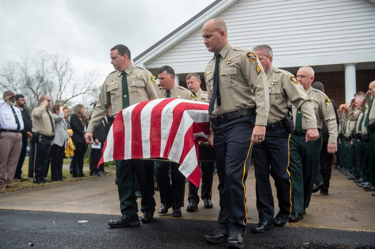 Members of law enforcement carry the casket of George County Sheriff’s Deputy Jeremy Malone to the hearse following Malone’s funeral at Agricola Baptist Church in George County on Friday, Jan. 12, 2024. Malone was shot and killed while conducting a traffic stop on Jan. 4.