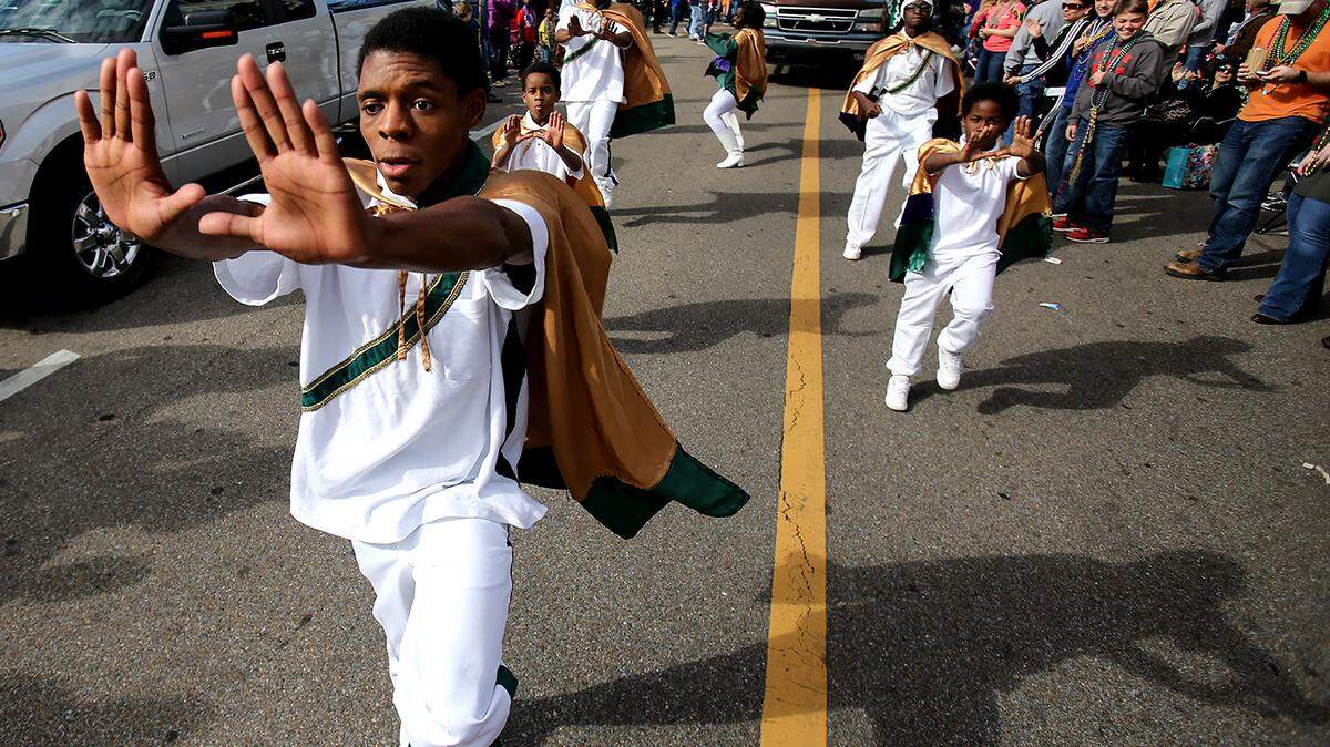AMANDA McCOY/SUN HERALDThe Untouchables dance their way down the street while walking in the the Krewe of Gemini parade on Saturday, February 6, 2016, in downtown Gulfport.
