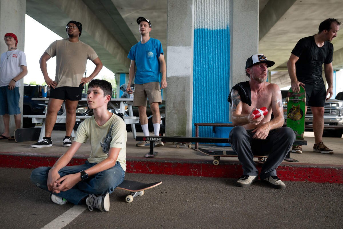 Skaters sit down to rest as Tyler Prowant gives a speech at the Biloxi DIY Skatepark.