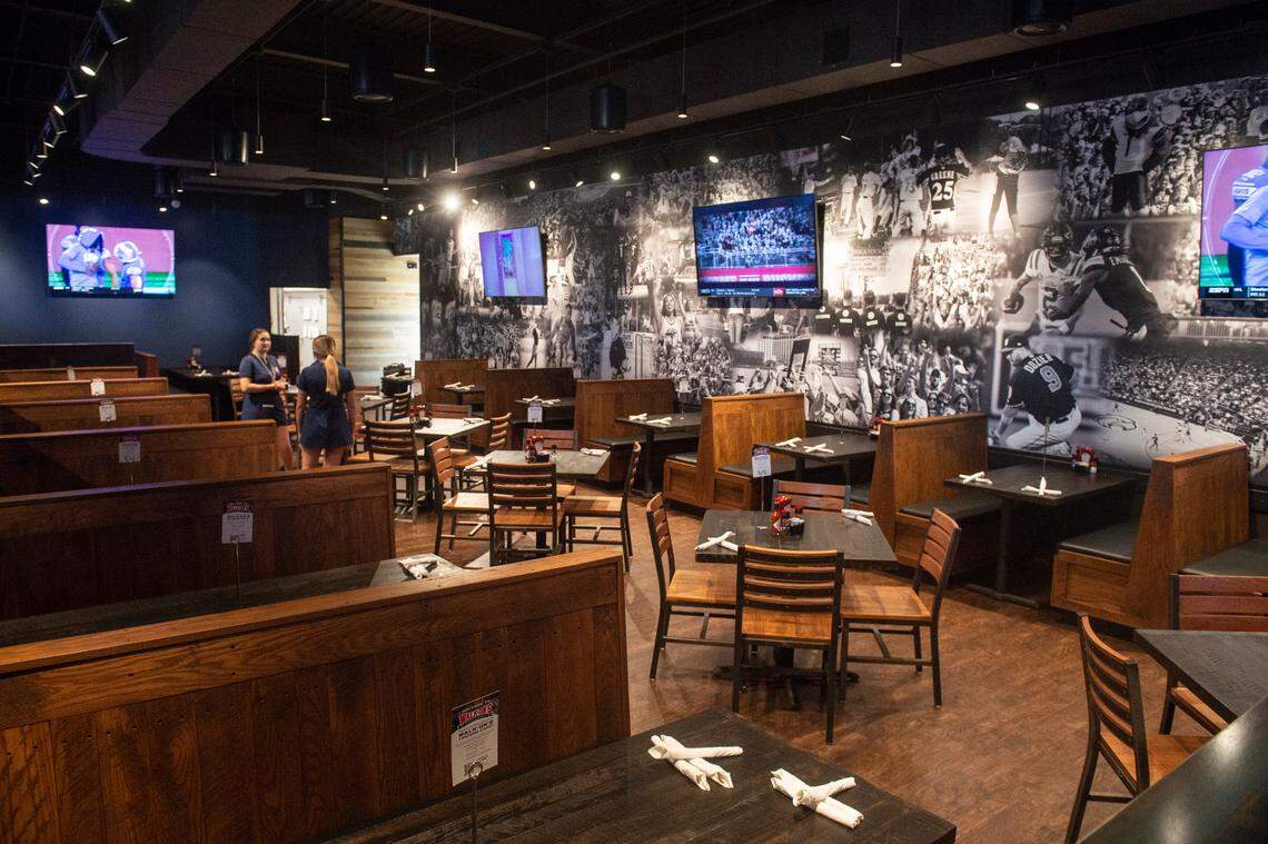 Sports pictures paper the main dining area of Walk-On’s Sports Bistreaux in D’Iberville, which offers both table and booth seating.
