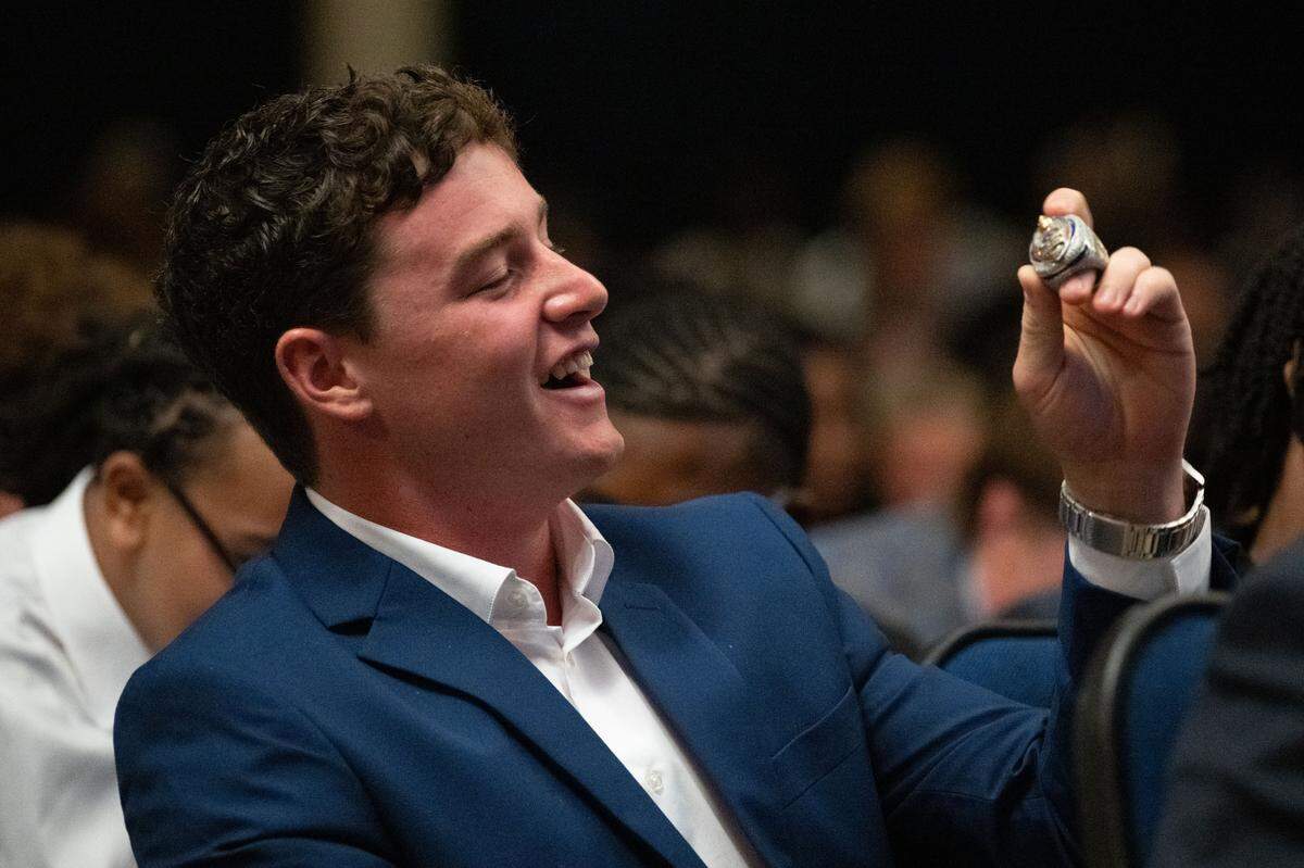 Quarterback Parker Nettles unboxes his championship ring Tuesday.