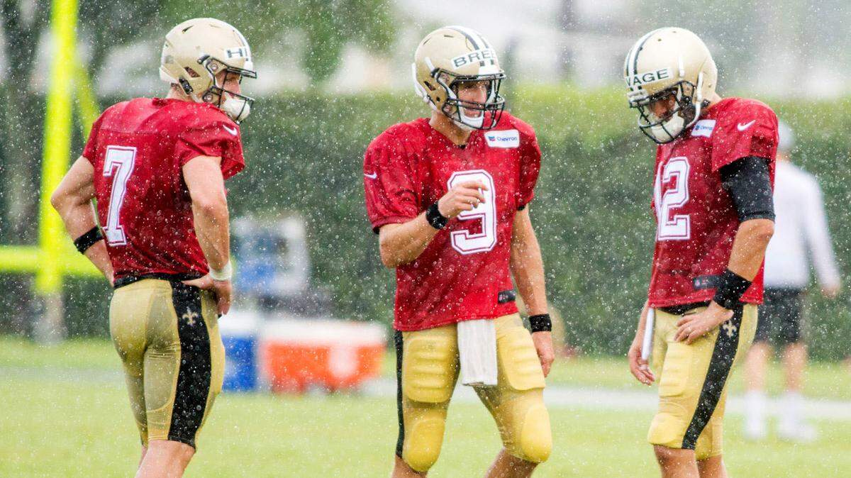 New Orleans Saints quarterbacks Taysom Hill, 7, and Tom Savage, 12, talk during training camp at the Sports Performance Center in Metairie, Louisiana on Monday.