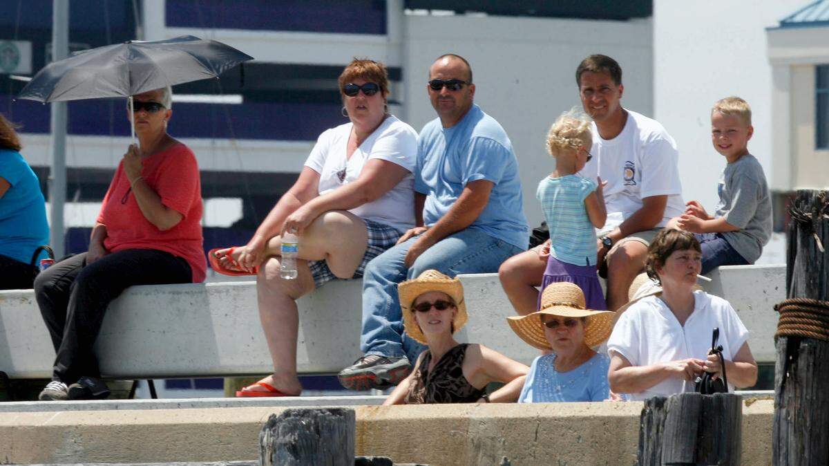 TIM ISBELL/SUN HERALD/FILE 
 People line the seawall of the Biloxi Small Craft Harbor to watch a past Blessing of the Fleet.