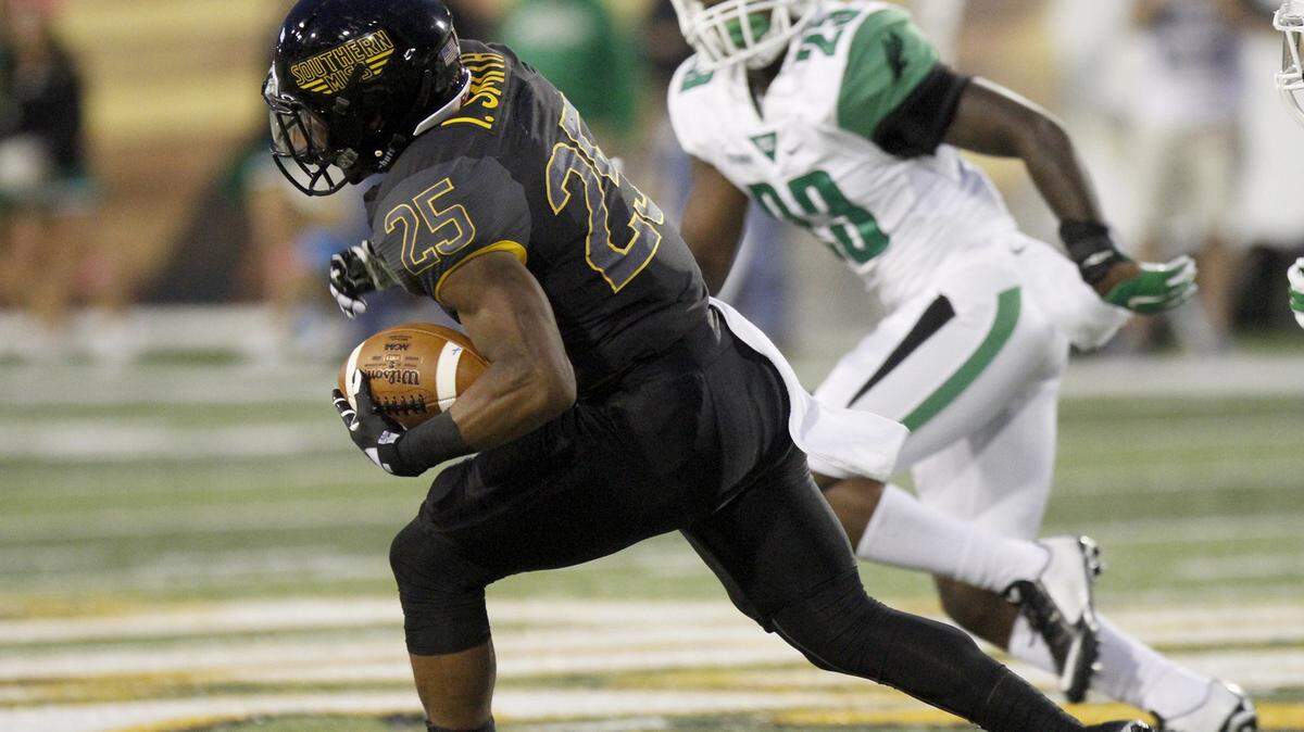TIM ISBELL/SUN HERALD 
 Southern Miss running back Ito Smith slices through the North Texas defense Saturday in Hattiesburg. USM travels to Marshall Saturday.
