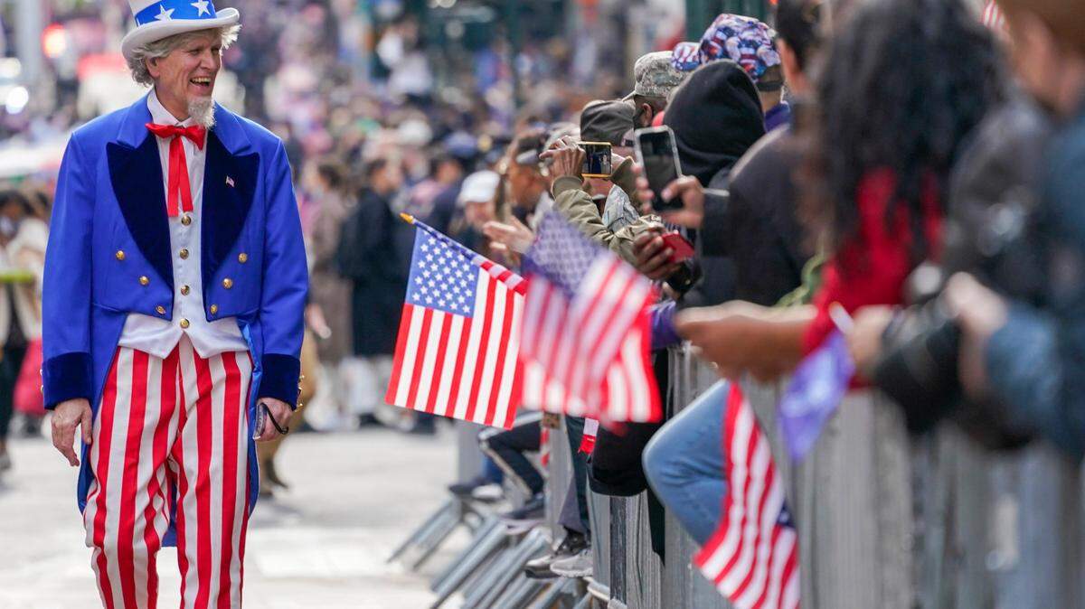 A participant dressed as Uncle Sam marches up Fifth Ave. during a Veterans Day parade in New York.