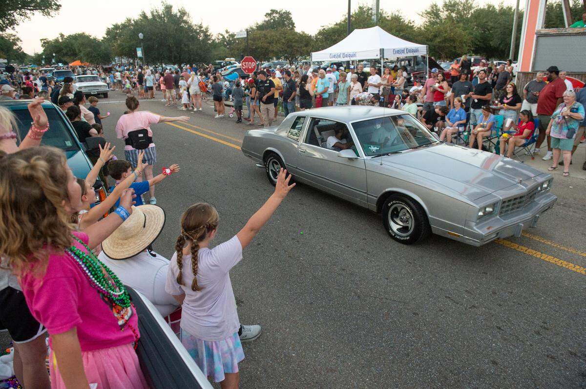 Spectators wave to the Cruisers during the Long Beach Parade in Long Beach, one of the events in Cruisin’ The Coast, on Monday, Oct. 7, 2024.