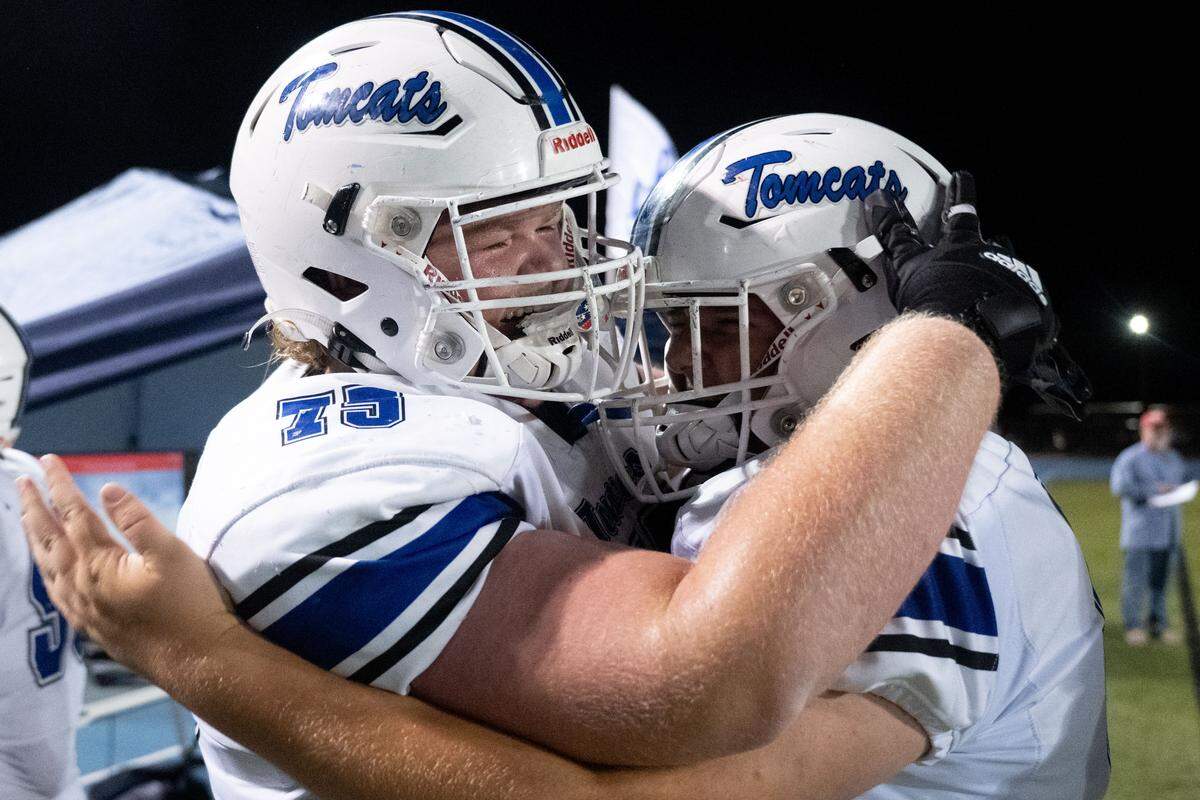 Stone offensive linemen Heath Ladner (75) and Riley Gibson (64) celebrate the Tomcats’ win Friday.