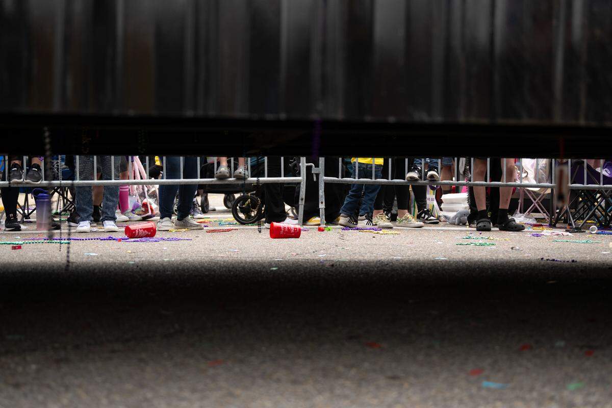 Trash from dropped throws accumulates on Lameuse Street.