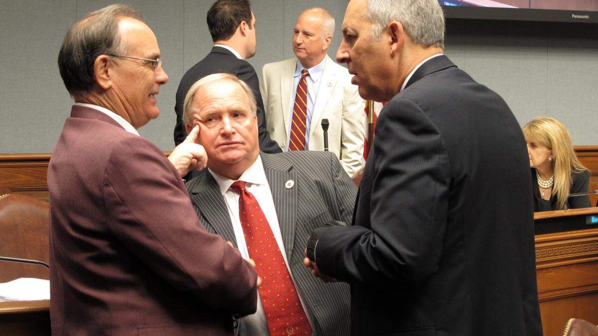 State Reps. Tony Bacala, R-Prairieville, left; Rick Edmonds, R-Baton Rouge, center; and Mark Abraham, R-Lake Charles, speak ahead of Gov. John Bel Edwards' budget cut presentation to the House Appropriations Committee, Tuesday, April 12, 2016, in Baton Rouge, La. Edwards is proposing to close a $750 million budget shortfall with cuts to the TOPS free college tuition program, safety net hospitals for the poor and public schools. (AP Photo/Melinda Deslatte)
