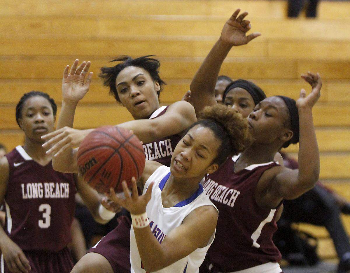 TIM ISBELL/SUN HERALDPascagoula's Victoria Hunter grabs a rebound over a host of Long Beach players at the Gautier Region Tournament, Monday, Feb. 15, 2016. 