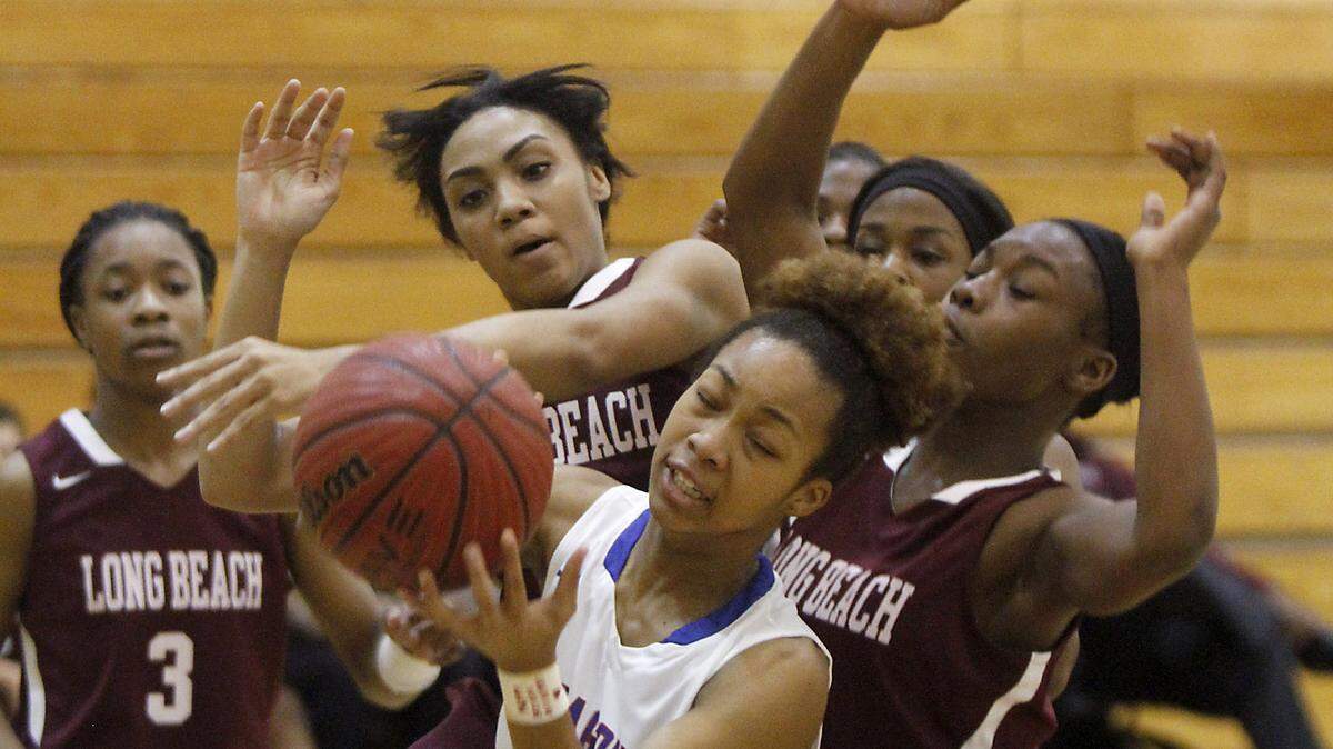 TIM ISBELL/SUN HERALDPascagoula's Victoria Hunter grabs a rebound over a host of Long Beach players at the Gautier Region Tournament, Monday, Feb. 15, 2016. 
