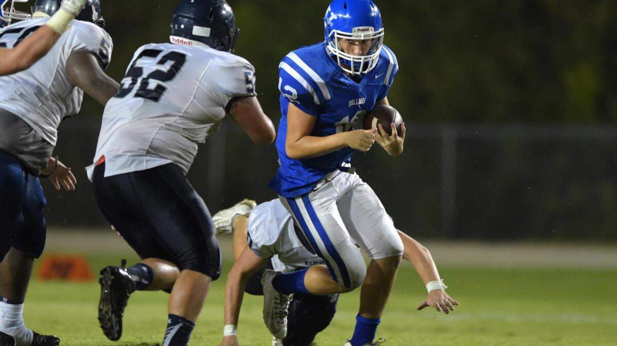 GLENN ANDREWS/SPECIAL TO THE SUN HERALD 
 Vancleave quarterback Parker Bourque (12) is tackled by Greene County defensive tackle Jacob Roberts (52) during the second quarter, Friday, Sept. 18, 2015, in Vancleave, Miss.