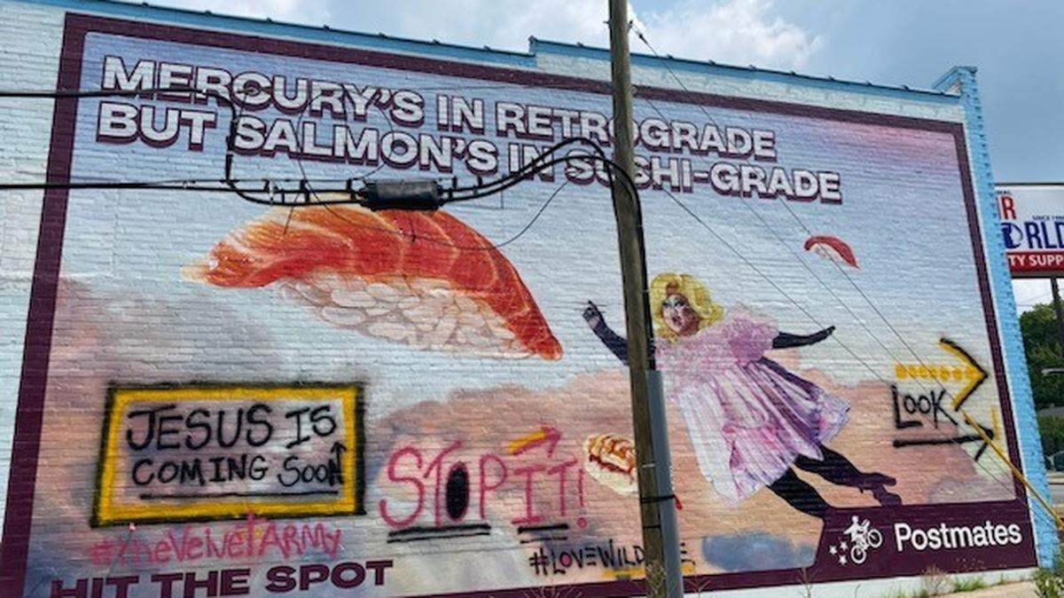 A Tennessee woman accused of defacing a mural that features drag queen Kim Chi was arrested and charged with vandalism, police said.
