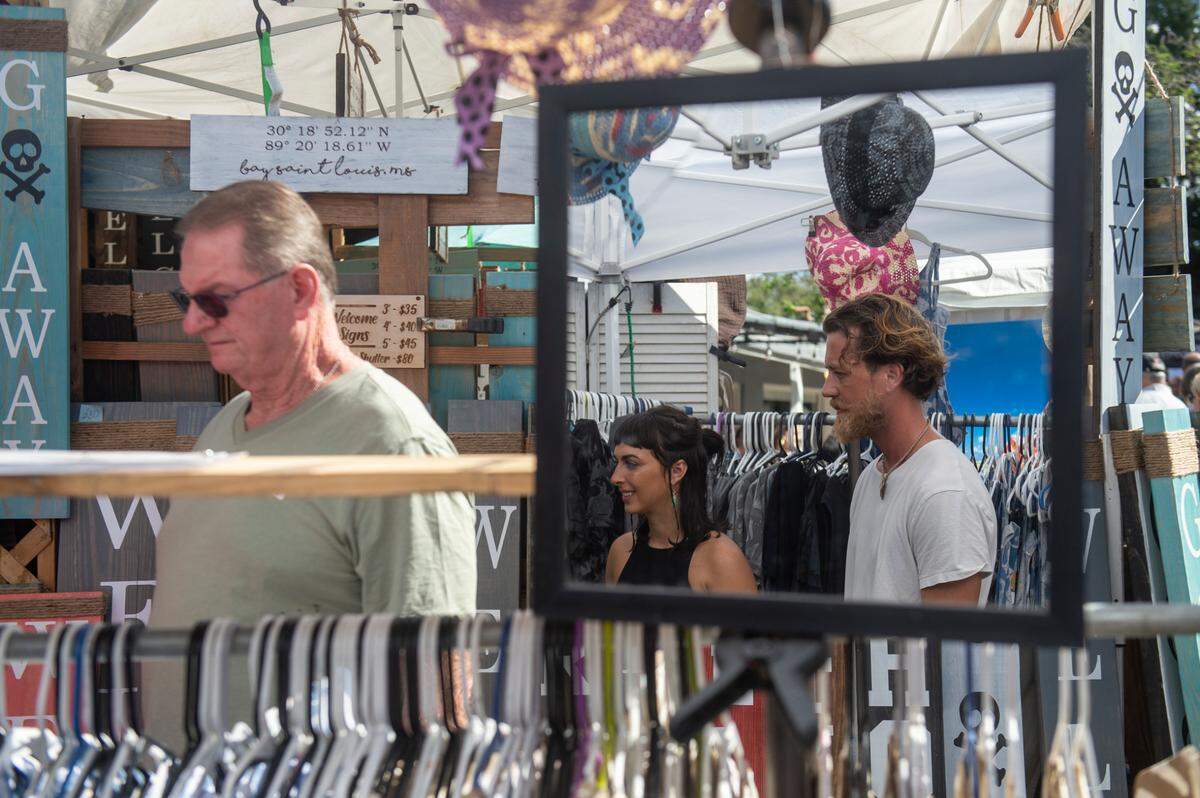 A couple bosses through dyed artisan fabrics during the Peter Anderson Festival in Ocean Springs on Sunday, Nov. 6, 2022.