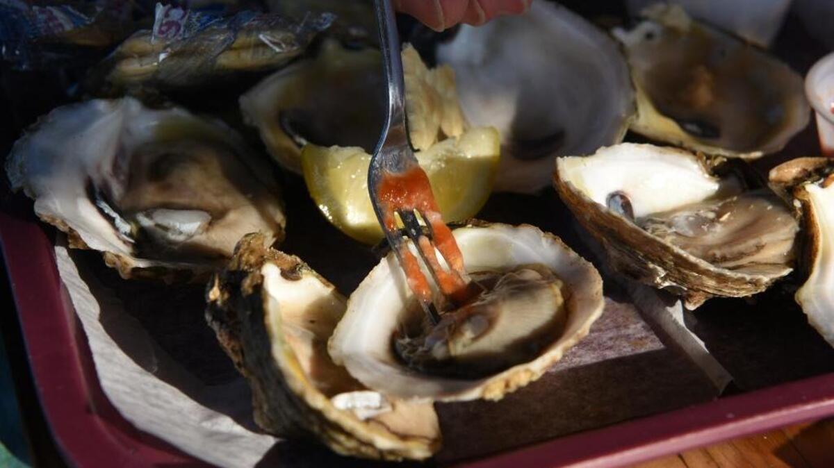 Ken McLeese visiting from Atlanta eats a plate of Apalachicola oysters on the half shell at Up The Creek Raw Bar Restaurant on May 26, 2016, in Apalachicola, Fla.