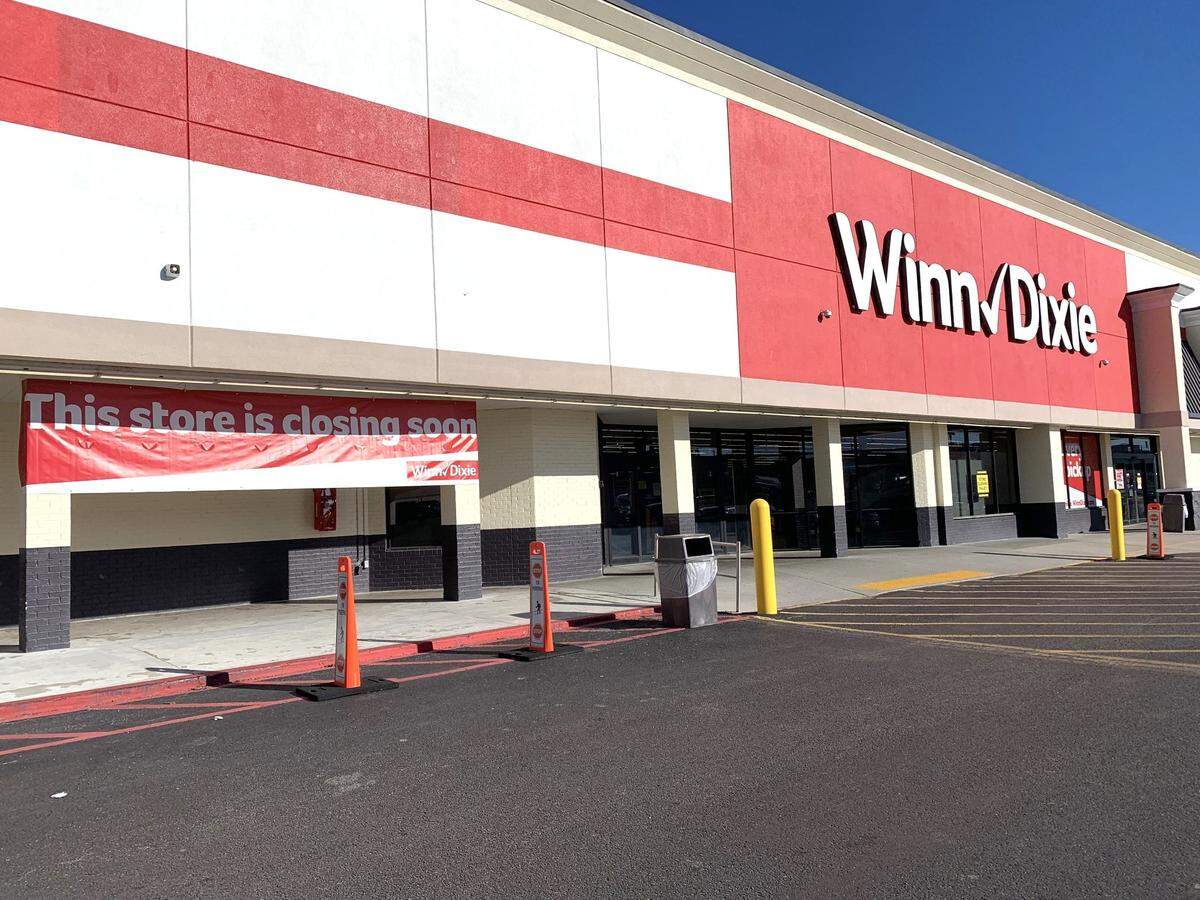 A banner outside a Coast Winn-Dixie store says the store is closing. This is the second Winn-Dixie market in South Mississippi being converted into an ADLI grocery store.
