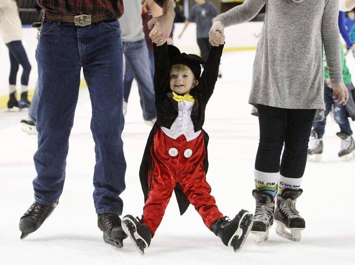 JOHN FITZHUGH/SUN HERALDLandon Marlowe, 3, of Vancleave gets help from his grandfather, Robert Ordalh and mother, Mary Marlowe as he ice skates at the Mississippi Coast Coliseum in Biloxi on Sunday.