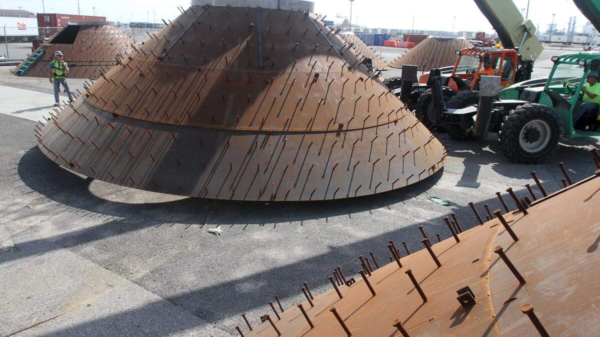 JOHN FITZHUGH/SUN HERALD 
 Employees of Mid South Industrial Inc. move one of the 40-foot wide hoppers at the state port in Gulfport on Friday Oct. 23, 2015. Employees of Mid-South Industrial Inc. are making 12 hoppers to go into the bottom of the 139-foot silos being built at the port.