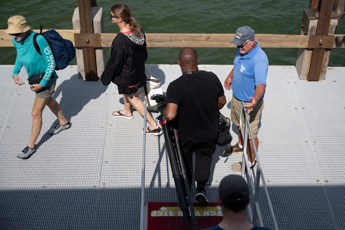 Visitors disembark from a Ship Island Excursions ferry to enjoy time on the barrier island 12 miles offshore on Wednesday.