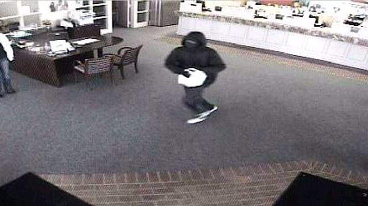 BILOXI POLICE DEPARTMENT 
 Police say this thin black man dressed in black robbed The First bank in Biloxi about 1:10 p.m. Friday. The bank is at Pass and Big Lake roads. The man was seen running into Pass Point Apartments at 282 Big Lake Road. Anyone who sees him is asked to call police at 392-0641.