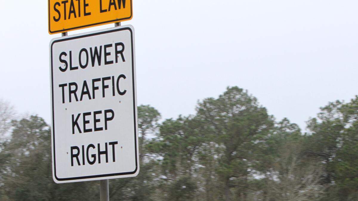 JOHN FITZHUGH/SUN HERALDA sign on I-10 in Jackson County advises motorists to stay in the right lane unless passing.