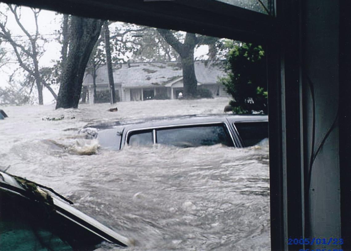 Cars float in the storm surge from Hurricane Katrina about 30 minutes before the water reached its peak in Biloxi on Aug. 29, 2005. In the background, Fred and Caroline Dunaway’s Kensington Drive home can be seen.