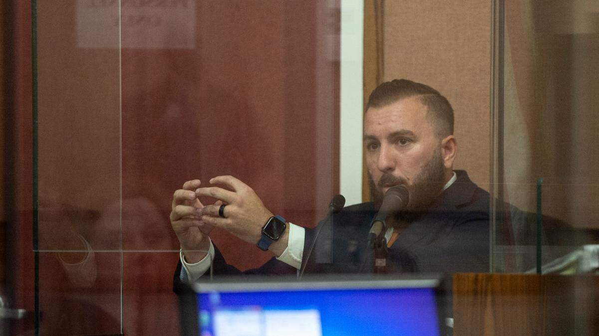Detective Justin Clifton testifies on the witness stand during a probable cause hearing for Denilson Marcus Elligson at Harrison County Court in Gulfport on Tuesday.