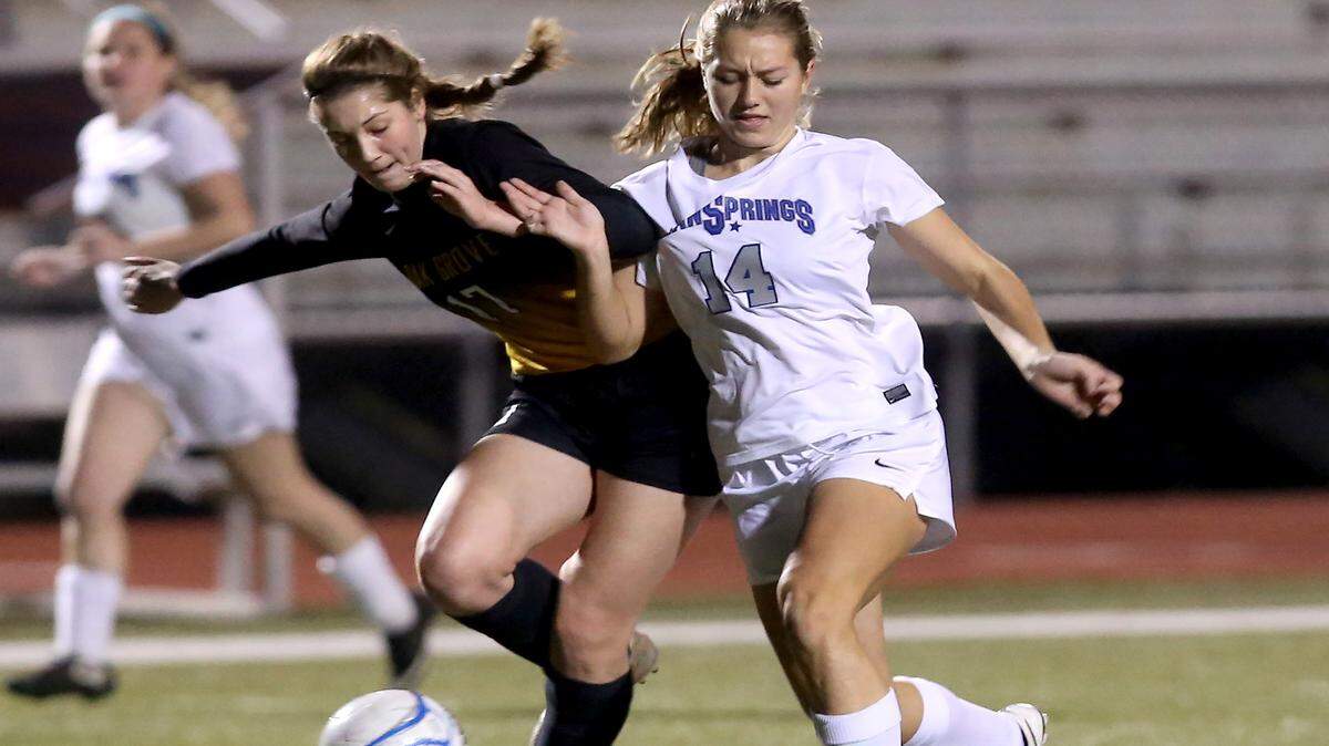 AMANDA McCOY/SUN HERALD 
 Oak Grove's Lauren Pitts, left, and Ocean Springs' Kaylee Foster compete for the ball during the first round of the Class 6A state playoffs on Monday, January 25 2016.