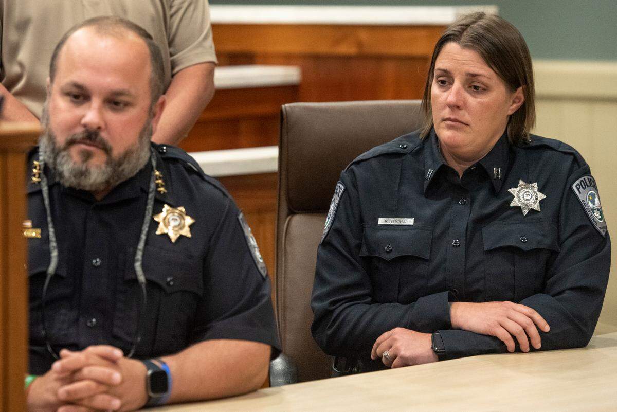 Bay St. Louis officers listen as Police Chief Toby Schwartz reflects on the lives of two fallen police officers during a press conference at the Hancock County administration building in Bay St. Louis on Thursday, Dec. 15, 2022.